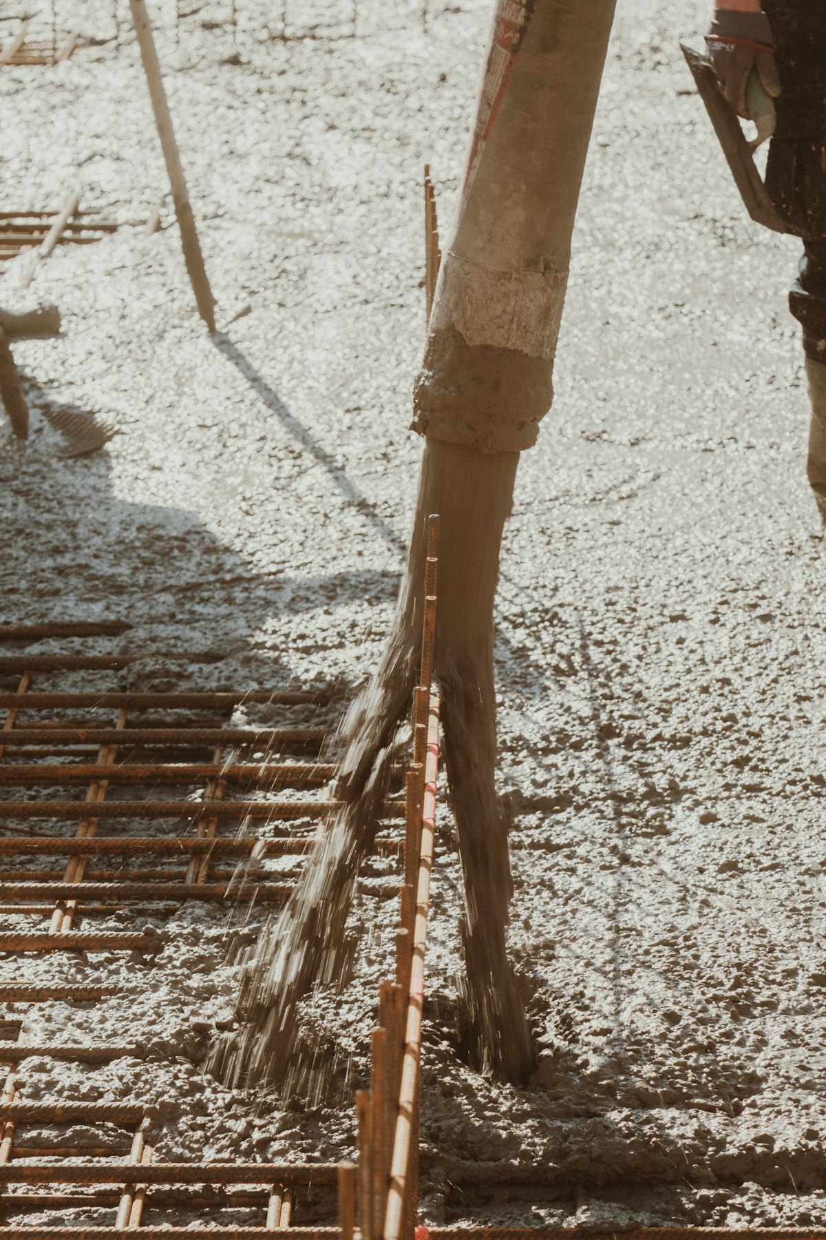 Workers pouring concrete into formwork on a fictional Formwork job