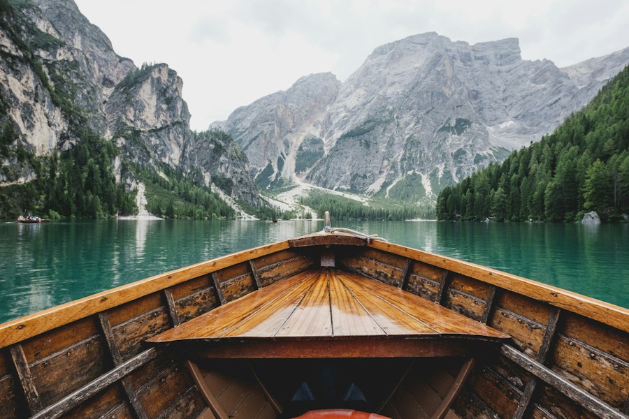 Canoes pulled onto a mirror-still alpine lake
