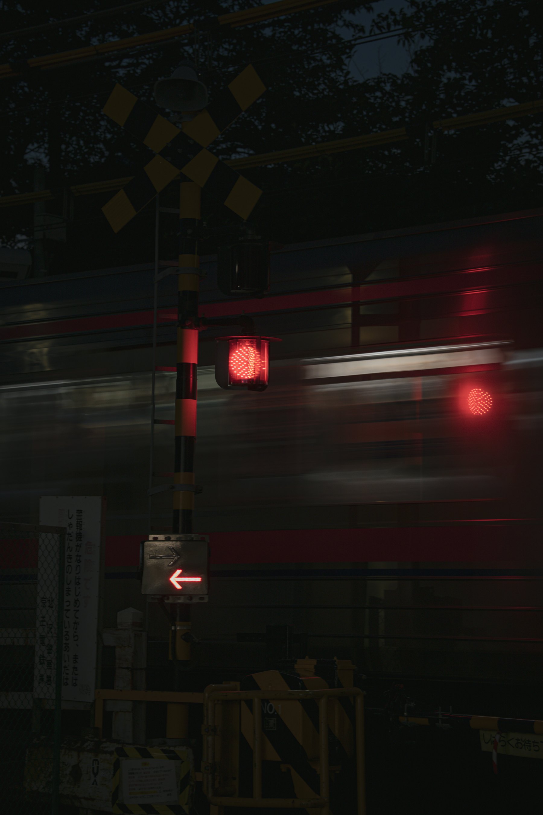 Blurred lights of a passing train seen from a dark carriage window at night
